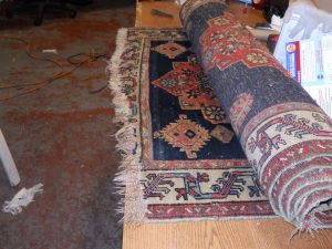 Persian Rug Cleaners in Berkeley, rug rolled up on surface